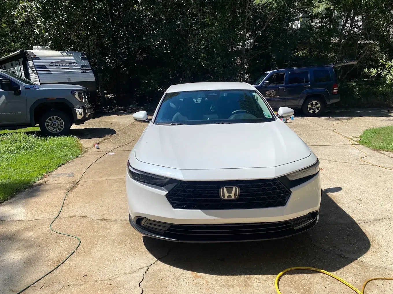 White Honda photographed in a driveway after detailing